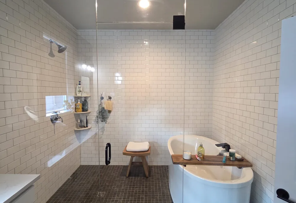 A walk-in shower and freestanding tub after a Milu deep clean