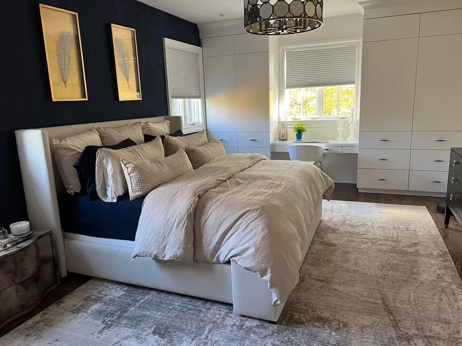 A bright primary bedroom with fresh linens after a Milu clean